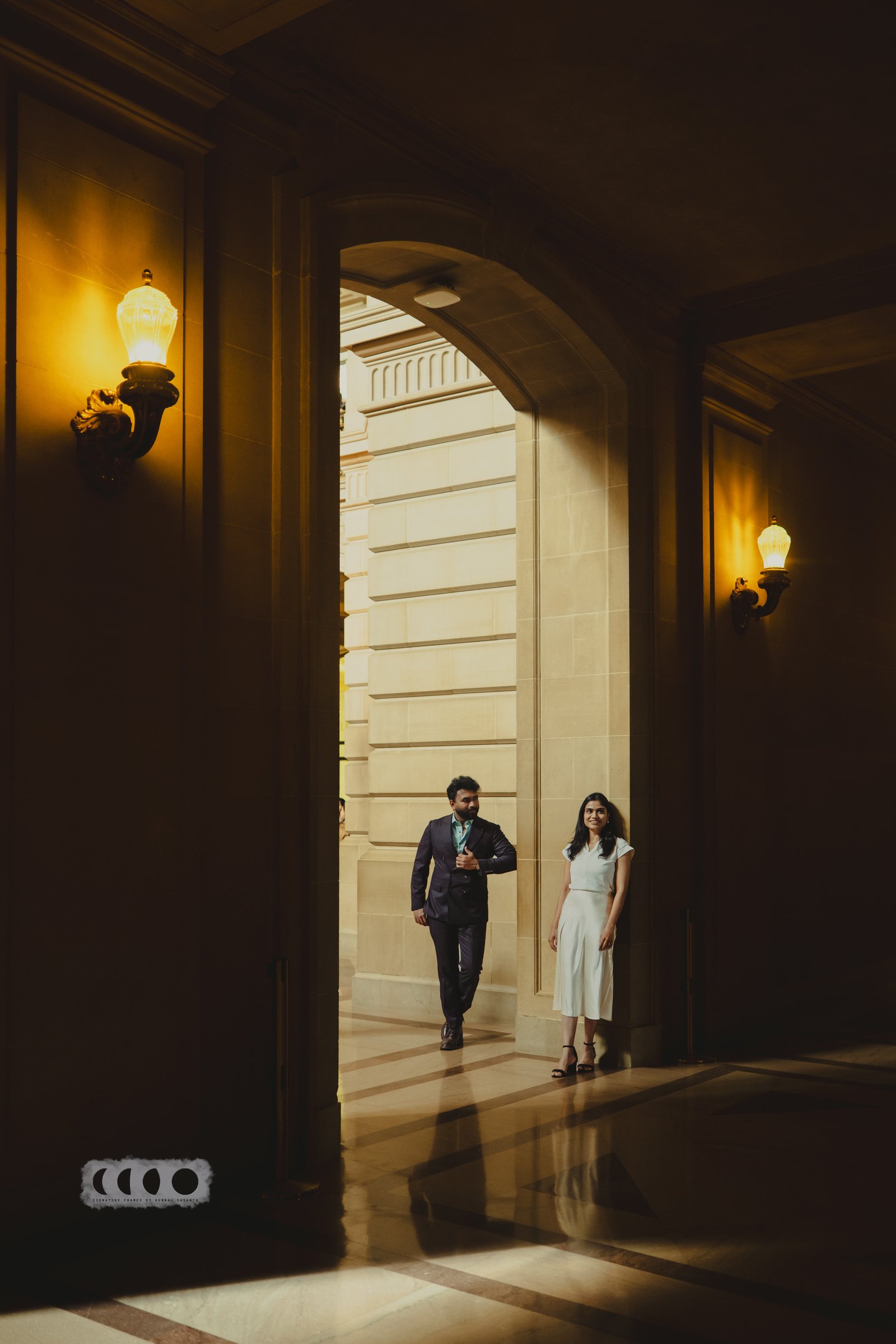 Sid and Janavi standing together in a warmly lit archway